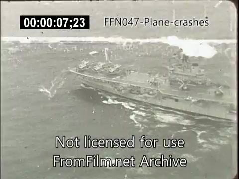 The still depicts a naval aircraft carrier navigating through rough waters, possibly in a crisis situation. The image suggests a historical context related to aviation incidents or crashes, possibly part of a newsreel compilation. The visible timestamp indicates that it is a segment of footage rather than a standalone image. The watermark notes that the footage is not licensed for use.