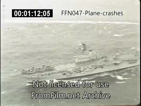 The still features a ship at sea, likely a naval vessel, amidst turbulent waters. The footage is part of a newsreel that captures plane crashes, possibly highlighting search and rescue efforts following such incidents. A timecode indicates it's 1 minute and 12 seconds into the film, and a watermark identifies the source as FromFilm.net Archive.