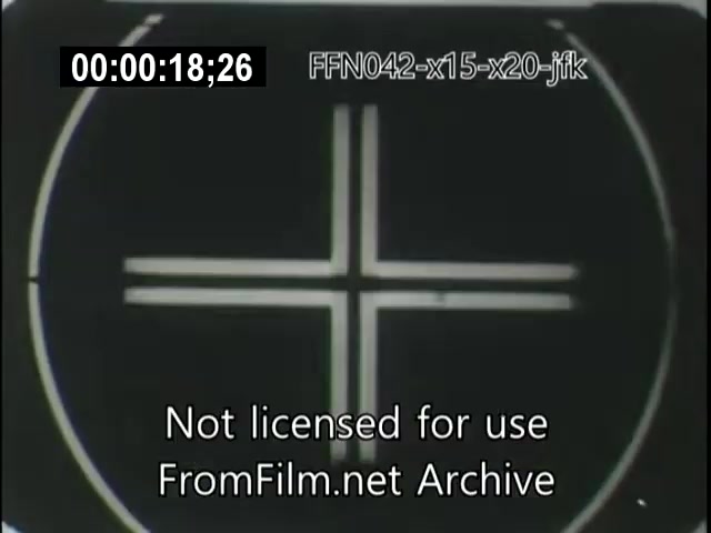 The still shows a black and white image featuring a crosshair design, commonly used in technical or aerial footage. The frame includes a timecode and a watermark indicating it is not licensed for use, and is part of archival material related to the X-15 and X-20 Dynasoar programs, as well as an allusion to JFK's era. The focus appears to be on a target or calibration mark, typical in film associated with aviation or aerospace testing.