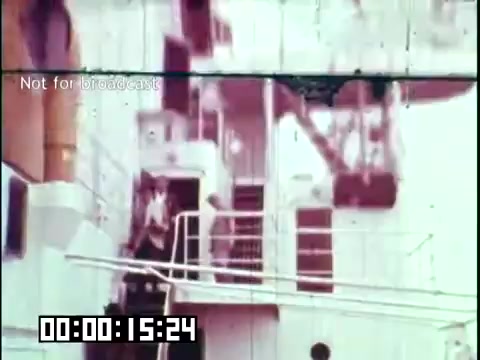 The still from the film 'Immigrant Heritage' features a scene aboard a ship, likely depicting immigrant passengers disembarking. The image captures a moment of transition, emphasizing themes of journey and heritage. It is presented in a vintage 16mm style, with a timestamp and a 'Not for broadcast' label, indicative of its educational purpose. The atmosphere suggests a historical context related to immigration, with a focus on the experiences of the Irish community.