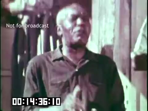 The still from 'Immigrant Heritage' features an animated man passionately expressing himself, likely singing or storytelling, set against a rustic backdrop. The image conveys a sense of cultural pride and showcases the rich traditions that the Irish Rovers aimed to highlight in the film. The muted colors suggest a vintage aesthetic typical of 16mm film. The text overlay indicates the footage is not for broadcast, emphasizing its archival nature.