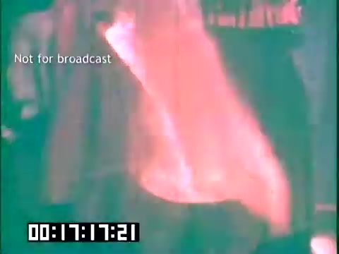 The still from 'Immigrant Heritage' features a visually warm and slightly blurred scene, likely depicting a lively moment related to Irish culture. The focus may be on a performer or cultural expression, underscored by the presence of a timestamp and a 'Not for broadcast' label, indicating this is an archival or behind-the-scenes glimpse. The overall aesthetic suggests a nostalgic and celebratory tone, characteristic of the educational film's themes surrounding Irish heritage and immigration.