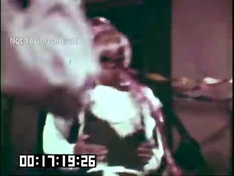 The still from 'Immigrant Heritage' features a vibrant scene likely depicting cultural elements important to Irish heritage, possibly involving performance or storytelling by the Irish Rovers. The image is bright and colorful, suggesting a lively atmosphere. The timestamp indicates it's a specific moment in the film, possibly highlighting a key theme or segment related to immigration and cultural identity.