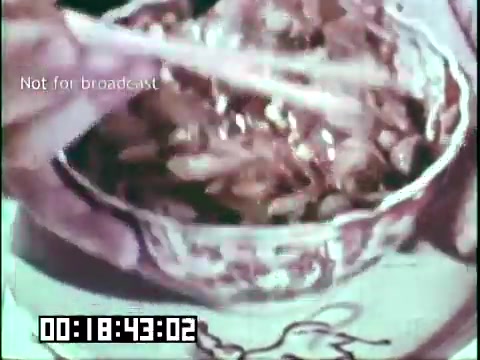 The still features a close-up of a bowl filled with food, being served with chopsticks. The imagery suggests a cultural or culinary exploration, likely highlighting the themes of immigrant heritage and multicultural influences within the context of the film 'Immigrant Heritage' with the Irish Rovers. The timestamp and 'Not for broadcast' label indicate it's a segment from a larger media piece, focusing on the integration of different traditions.