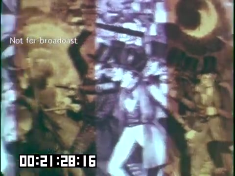 The still from 'Immigrant Heritage' features a colorful collage with overlapping images and dynamic patterns. It likely represents themes of cultural history and storytelling, possibly linked to Irish immigration. The presence of text indicating 'Not for broadcast' suggests it is part of an unreleased or restricted viewing. The timestamp suggests a specific moment within the film, emphasizing its educational and artistic value.