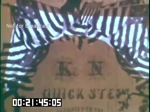 The still from 'Immigrant Heritage' features a visual of a stage or presentation, adorned with striped curtains. The backdrop appears to incorporate text or graphics related to 'quick step,' likely referencing a cultural or historical theme relevant to the content of the educational film. The overall tone suggests a focus on heritage and culture, potentially emphasizing the experiences of Irish immigrants.