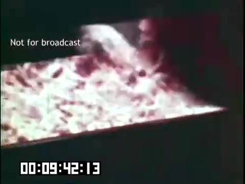 The still from 'Immigrant Heritage' features a close-up shot of a glowing substance, likely coal or embers, suggesting themes of hard work and industry. The text 'Not for broadcast' indicates this is likely an unedited portion of the film. The timestamp provides context for its placement within the film's narrative. The overall mood is warm, possibly symbolizing the labor and traditions of immigrant communities.