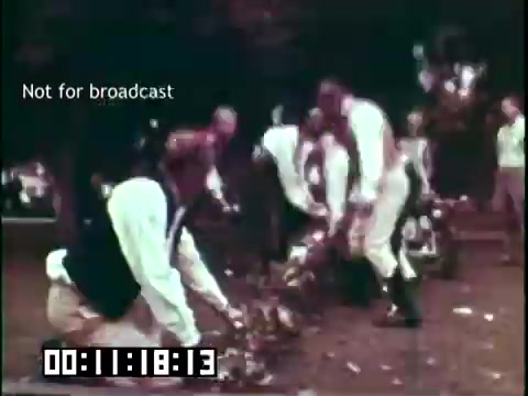 The still depicts a scene from the educational film 'Immigrant Heritage' featuring the Irish Rovers. It shows a group of individuals, likely performers or participants, engaging in an activity outdoors. They are dressed in traditional attire, suggesting a cultural or historical representation. The text 'Not for broadcast' indicates that this is a restricted image intended for internal use. The timestamp suggests it occurs around 11 minutes into the film.