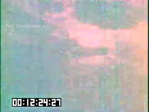 The 16mm still from 'Immigrant Heritage' features a washed-out, abstract visual likely due to the film's age or processing. The text 'Not for broadcast' indicates it's not intended for public viewing. The timestamp suggests a moment in the film, but the content is unclear. The film connects to themes of immigration and cultural heritage, likely showcasing the experiences of Irish immigrants through music or storytelling.