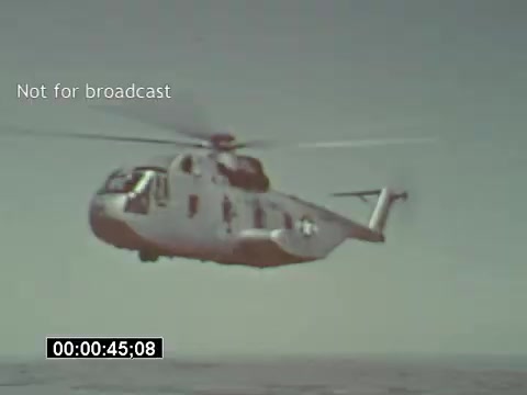 The still from the 'USAF Helicopter Training' footage features a Bell UH-1 Huey helicopter in flight, captured from a 16mm print. The helicopter is shown airborne over a vast body of water, showcasing its distinctive design and military markings. The image is branded 'Not for broadcast,' indicating it's intended for limited viewing, likely for educational or archival purposes. The timestamp suggests it captures a moment approximately 45 seconds into the footage.