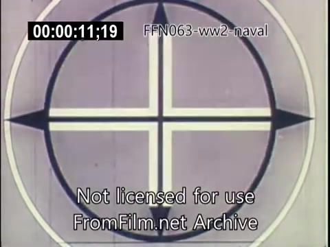 The still features a graphic design consisting of a circular pattern with a cross emblem at the center, indicative of a target marking used in naval warfare. The image is part of US naval footage from World War II focusing on kamikaze attacks. The visual elements reflect the military context of the era, emphasizing the tactics and threats faced by naval forces. The time code and warning indicate that it is part of a larger archival film.