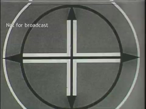 The still features a test pattern commonly used in television broadcasts, consisting of a circular design with a cross in the center, divided into quadrants. The text 'Not for broadcast' is displayed in the top left corner. This indicates that the footage is likely intended for internal screening or testing rather than public airing.