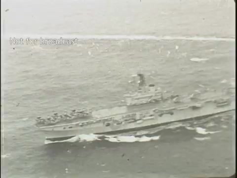 The still captures a naval ship navigating through choppy waters, with visible waves and a blurred horizon. The vessel appears to be carrying personnel on its deck, suggesting a military or rescue operation. The grayscale tone of the footage adds a historical context, characteristic of older news broadcasts. The label 'Not for broadcast' indicates its archival nature.