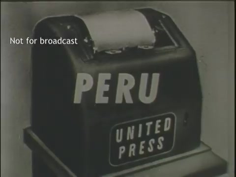 The still features a vintage news ticker machine displaying the word 'PERU' prominently, alongside the label 'UNITED PRESS.' The background likely suggests a news reporting context, relevant to the theme of assorted footage of plane crashes and similar incidents. The machine's design reflects the era of early news dissemination technology. The caption 'Not for broadcast' indicates that this image is intended for specific usage rather than public airing.