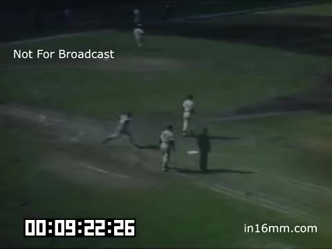 The still depicts a moment from a Detroit Tigers game at Briggs Stadium during the late 1940s. Players are visible on the field, with one player running towards a base. The scene captures the dynamic atmosphere of a baseball game, showcasing the action and excitement typical of that era. The footage is marked 'Not For Broadcast,' indicating it is likely archival material. The timestamp at the bottom suggests it is part of a larger reel, contributing to the historical context of the Detroit Tigers during that time period.