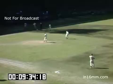 The still is from 16mm Kodachrome footage of a Detroit Tigers baseball game at Briggs Stadium, dated between 1948 and 1950. It features players on the field, with some visible in action while others are stationed in their positions. The infield and outfield are visible, with some spectators seen in the background. The frame includes a timestamp and a 'Not For Broadcast' label, indicating its archival nature. The overall atmosphere captures a historical moment in baseball during the late 1940s.