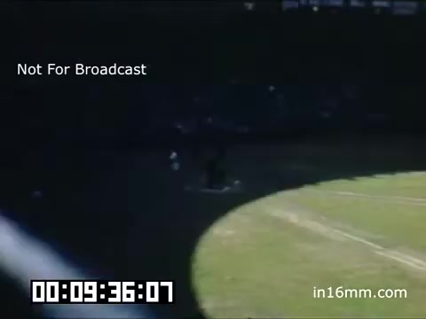 The still from the 16mm footage of a Detroit Tigers game at Briggs Stadium (1948-1950) captures a moment on the baseball field, showcasing the vibrant atmosphere typical of the era. The image suggests a sunny day with shadows cast on the field, indicating the time of day. Players can be seen engaged in gameplay, while the stands appear filled with spectators enjoying the game. The footage's color—likely reminiscent of Kodachrome's vivid hues—adds to the nostalgic feel of mid-20th century American baseball. The watermark indicates it is not for broadcast, preserving its historical context.