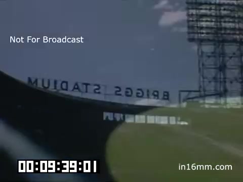 The 16mm still captures a scene from Briggs Stadium during a Detroit Tigers game between 1948 and 1950. It prominently features the stadium's name, 'Briggs Stadium,' displayed in a retro style. The image is characterized by a vintage aesthetic typical of Kodachrome film from that era, showcasing a grassy field and stands, likely filled with spectators. A timestamp indicates the footage length, while the overlay text notes that it is not for broadcast, indicating its archival nature.