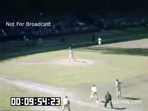 The still from the 16mm footage captures a moment during a Detroit Tigers game at Briggs Stadium between 1948 and 1950. The scene shows players on the field, with a clear view of the diamond and the surrounding audience in the background. The vibrant colors typical of Kodachrome film highlight the historical context and atmosphere of a mid-20th-century baseball game. The timestamp at the bottom indicates elapsed footage time, and the 'Not For Broadcast' label suggests this is archival material meant for specific uses, rather than public distribution.
