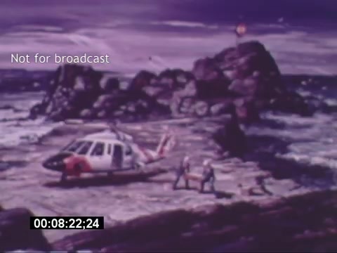 The still from the 'Sikorski S-76 Promotional Film' depicts a Sikorsky S-76 helicopter situated on a rocky landscape, likely near a shoreline. Personnel are seen interacting near the helicopter, which features a distinctive design with a white and red color scheme. The surrounding environment appears rugged, with waves crashing against the rocks. A beacon or light source can be seen in the background. The watermark 'Not for broadcast' indicates the image is intended for limited distribution. The timecode suggests the frame is captured at approximately eight minutes into the film.
