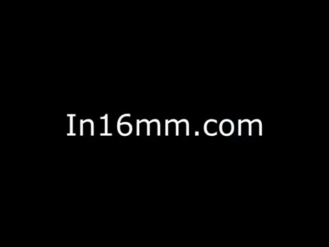The still appears to display a simple, solid black background overlaid with white text that reads 'In16mm.com.' This indicates a focus on 16mm film content, possibly serving as a title card or identifier for the promotional film about the Sikorsky S-76 helicopter. The lack of visual imagery suggests a potentially straightforward promotional focus, emphasizing the film's nature rather than specific content or style.