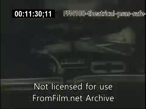 The still appears to depict a scene from a 16mm theatrical public service announcement from 1949 focused on safe driving. It features a vintage car, likely emphasizing the importance of road safety practices. The black-and-white footage captures the style and tone of post-war America, aiming to raise public awareness about cautious driving. The digital overlay indicates that the material is not licensed for public use and is preserved from an archive.