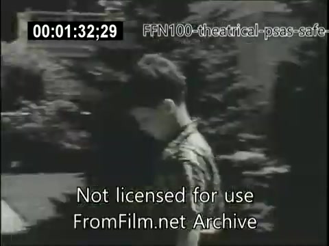 The still depicts a young boy walking outdoors, likely in a suburban setting, with trees and shrubs visible in the background. The overall tone is somber, conveying a message regarding safe driving. The image is part of 1949's theatrical public service announcements aimed at promoting road safety.