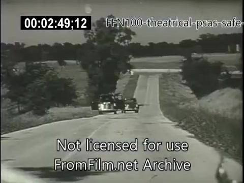 The still shows a rural road with two cars approaching each other. The setting appears sunny and open, highlighting a typical mid-20th century American landscape. The focus on the vehicles suggests a message about road safety, in line with the purpose of the 1949 theatrical public service announcements for safe driving. The image emphasizes clear visibility and the importance of vigilant driving behavior.