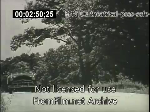 The still from the 1949 theatrical public service announcement for safe driving features a vintage car driving along a rural road, surrounded by greenery and trees. The scene emphasizes safe driving practices during a time when road safety was becoming increasingly important. The black-and-white film captures a nostalgic feel, likely intended to evoke a sense of responsibility among drivers. The overlay text indicates that the clip is not licensed for use and is sourced from an archive.