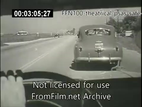 The still features a view from the driver's perspective inside a car, showing a road scene typical of the late 1940s. Another vehicle, a classic sedan, is visible ahead, highlighting everyday driving conditions. The black-and-white format reflects the era, and the image serves as a backdrop for a public service announcement promoting safe driving practices. Text indicating it's from an archive is present, suggesting it is part of a historical campaign.