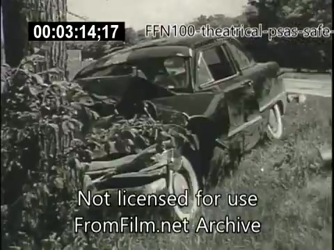 The still depicts a damaged car, likely from a collision, partially obscured by tall grass and bushes. It emphasizes the consequences of unsafe driving, serving as a visual warning in a 1949 public service announcement. The scene conveys a sense of caution and the need for road safety awareness.