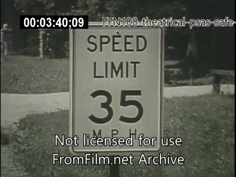 The still shows a road sign indicating a speed limit of 35 miles per hour (MPH). The background features greenery, likely in a residential or park area, emphasizing the context of safe driving in a public service announcement from 1949. The image captures a moment focused on promoting road safety.