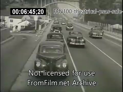 The still depicts a black-and-white scene from a 1949 theatrical public service announcement promoting safe driving. The image shows a busy road with several vintage cars traveling under a bridge, highlighting the traffic conditions of the era. It serves as a visual reminder of the importance of road safety. The text overlay indicates that it is part of the FFN100 archive and not licensed for use.