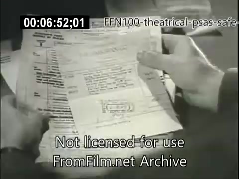 The still features a close-up of a person's hands holding documents, possibly related to driving or automobile safety. It captures a moment of scrutiny or concern, likely emphasizing the importance of safe driving practices. The context suggests it's part of a 1949 public service announcement aimed at raising awareness about road safety. The text at the bottom indicates the image is not licensed for use.