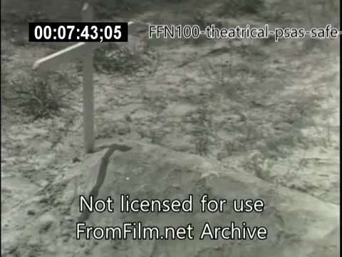 The still depicts a grave marked by a simple wooden cross in a barren, sandy landscape. This imagery likely serves as a somber reminder of the consequences of unsafe driving, typical of public service announcements from 1949 aimed at promoting road safety. The scene emphasizes the serious impact of traffic accidents.