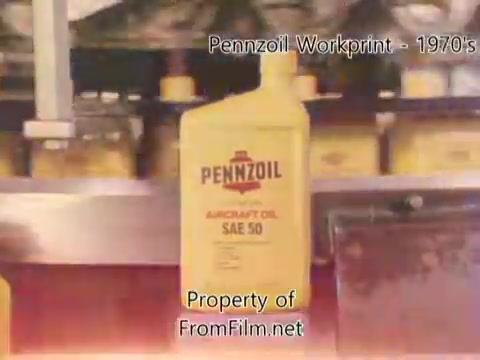 The still features a prominent Pennzoil oil bottle labeled 'AIRCRAFT OIL SAE 50,' set against a background of similarly branded products. The image appears to be a workprint from a 16mm negative, indicating its production during the 1970s or 1980s. Debris is noted in the film gate, suggesting it's part of the original film's condition rather than an issue with the projector. The accompanying music is by Underbelly, with tracks that include 'I Hear Voices,' 'Asterism,' 'Italy Jr.,' and 'Land's End.'