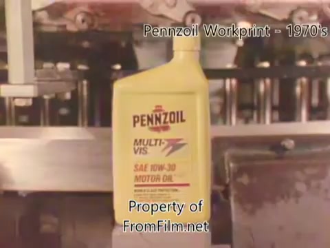 The still from the 'Pennzoil Factory/Refinery Workprint - 1980s' features a close-up of a Pennzoil motor oil bottle. The label prominently displays 'MULTI-VIS' and 'SAE 10W-30,' indicative of the product's specifications. In the background, machinery related to the refinery is visible, suggesting an industrial setting. The film shows some debris in the film gate, a common occurrence in older film prints. The accompanying music, from Underbelly, includes tracks that enhance the visual presentation.