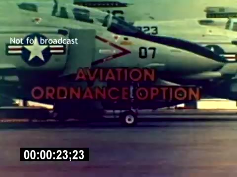 The still features military aircraft lined up on a tarmac, showcasing the U.S. Marine Corps' Aviation Ordnance option. In bold letters, the text 'AVIATION ORDNANCE OPTION' is displayed, emphasizing the focus of the recruiting film. The scene conveys a sense of professionalism and military readiness, typical of recruitment materials. The note 'Not for broadcast' suggests the content is intended for internal or specific audiences rather than public viewing.