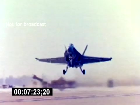 The still depicts a military aircraft, likely a jet, in the process of taking off. The focus is on the aircraft as it ascends from the runway, showcasing its wings and landing gear. The background is blurred, suggesting motion, while the colors have a slightly washed-out look typical of older film stock. The timestamp on the bottom indicates it's from the eighth minute of the film, highlighting its sequence within the recruiting narrative for USMC Aviation Ordnance. The absence of a soundtrack implies that this segment emphasizes visual action over audio cues.