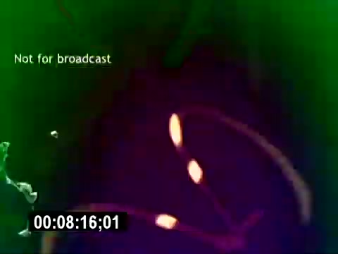 The still features colorful, abstract graphics with swirls and lines, accompanied by the text 'Not for broadcast.' The background is a blend of green and purple hues, likely meant to capture attention. The time stamp indicates it is part of a silent segment from the 'USMC Aviation Ordnance Recruiting Film.' The visual style seems designed to be engaging and dynamic.