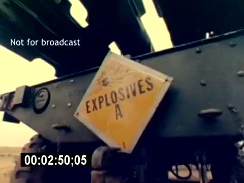 The still from the 'USMC Aviation Ordnance Recruiting Film - Silent' depicts a close-up of a sign labeled 'EXPLOSIVES A' attached to military equipment, emphasizing safety and caution. The background suggests a desert or military setting, indicative of an ordnance-related environment. The caption 'Not for broadcast' is displayed, indicating restrictions on sharing this footage. The timestamp shows it's part of a longer sequence at 2 minutes and 50 seconds.