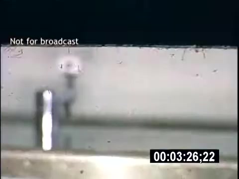 The still from 'College Days - 1956 home movie' appears to depict a close-up view of a surface, likely a tabletop or lab setup. There is a prominent vertical object, possibly a test tube or similar container, alongside what seems to be droplets on the surface, suggesting a scientific or experimental context. The frame is marked 'Not for broadcast,' indicating it's intended for private viewing only. The timestamp at the bottom further contextualizes it within the movie.