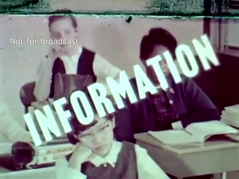 The still from 'IBM - The Information Center' (1963) features students in a classroom setting. The word 'INFORMATION' is prominently displayed across the image, indicating the focus on data and technology in education. The scene exemplifies the integration of IBM computer technology, particularly punch cards, into academic processes like grading and course enrollment, highlighting the innovative approach to educational needs at that time.