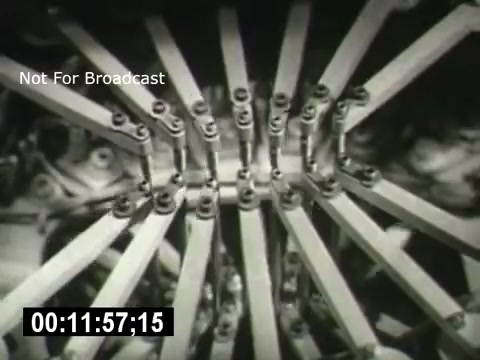 The still from 'Bell System - Story Without End' showcases a close-up of mechanical components, featuring a complex arrangement of levers and connectors. The image likely illustrates the intricate machinery involved in telecommunications, highlighting the technological sophistication of the Bell System. The visual evokes a sense of industrial precision and innovation.