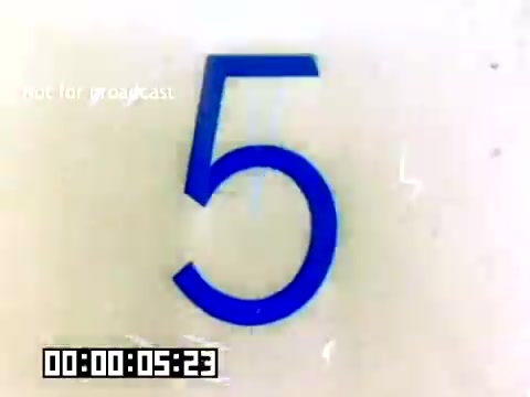 The still features a prominent blue numeral '5' against a light background, indicating a countdown or segment in the film. Beneath the number, there is a timecode displaying '00:00:05:23,' suggesting it's a timestamp from a 16mm silent Kodak sales film from 1977. The overlay 'Not for broadcast' indicates this is a promotional or internal piece. The visual is simple and straightforward, focusing on the countdown element.