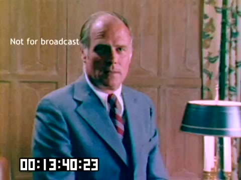 The still features a middle-aged man in formal attire, seated in a well-furnished room with wooden paneling. He has a serious expression and appears to be looking directly at the camera. A stylish lamp is positioned on a table in front of him. The overlay text indicates that the footage is not intended for broadcast, and the timestamp at the bottom suggests the specific moment in the film. The overall color palette reflects the aesthetic of the late 1970s.