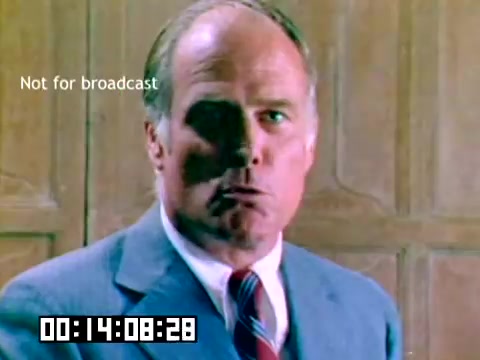 The still features a middle-aged man in a suit, looking directly at the camera with a serious expression. He has short hair and appears to be in a professional setting, possibly a conference or presentation environment. The background is wooden, suggesting a classic or formal interior. The timestamp in the lower left corner indicates the duration of the clip, and there's a watermark stating 'Not for broadcast,' emphasizing the nature of the film as a sales presentation.