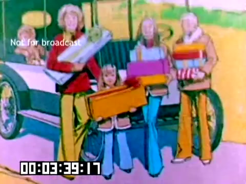 The still features a colorful cartoonish illustration of a family, including adults and a child, standing beside a vintage car. They are holding various items, likely gifts or supplies, indicating a joyful occasion. The clothing reflects the styles of the 1970s, with bell-bottoms and vibrant colors. The scene conveys a sense of nostalgia and family togetherness, typical of Kodak's messaging. The timestamp and 'Not for broadcast' label are prominently displayed at the bottom.