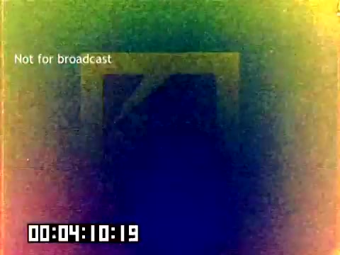 This 16mm still features a visual that is predominantly color-shifted with a gradient effect, creating a psychedelic appearance. In the center, there is a faint, abstract logo or shape, likely related to Kodak. The text 'Not for broadcast' is visible at the top, indicating the film's intended use. A timestamp at the bottom shows the duration, suggesting it is part of a longer presentation. The overall aesthetic resembles experimental film techniques often seen in the 1970s.