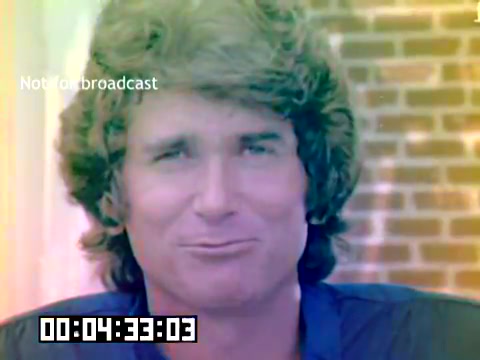 The still is from a 1977 Kodak sales film featuring a close-up of a man with a prominent hairstyle, likely Michael Landon. He appears to be smiling or expressing a playful emotion, with a blurred backdrop of brick walls. The image has a vintage color palette, and it includes a timestamp at the bottom, indicating its duration. The text 'Not for broadcast' is overlayed, emphasizing its commercial and non-public nature.